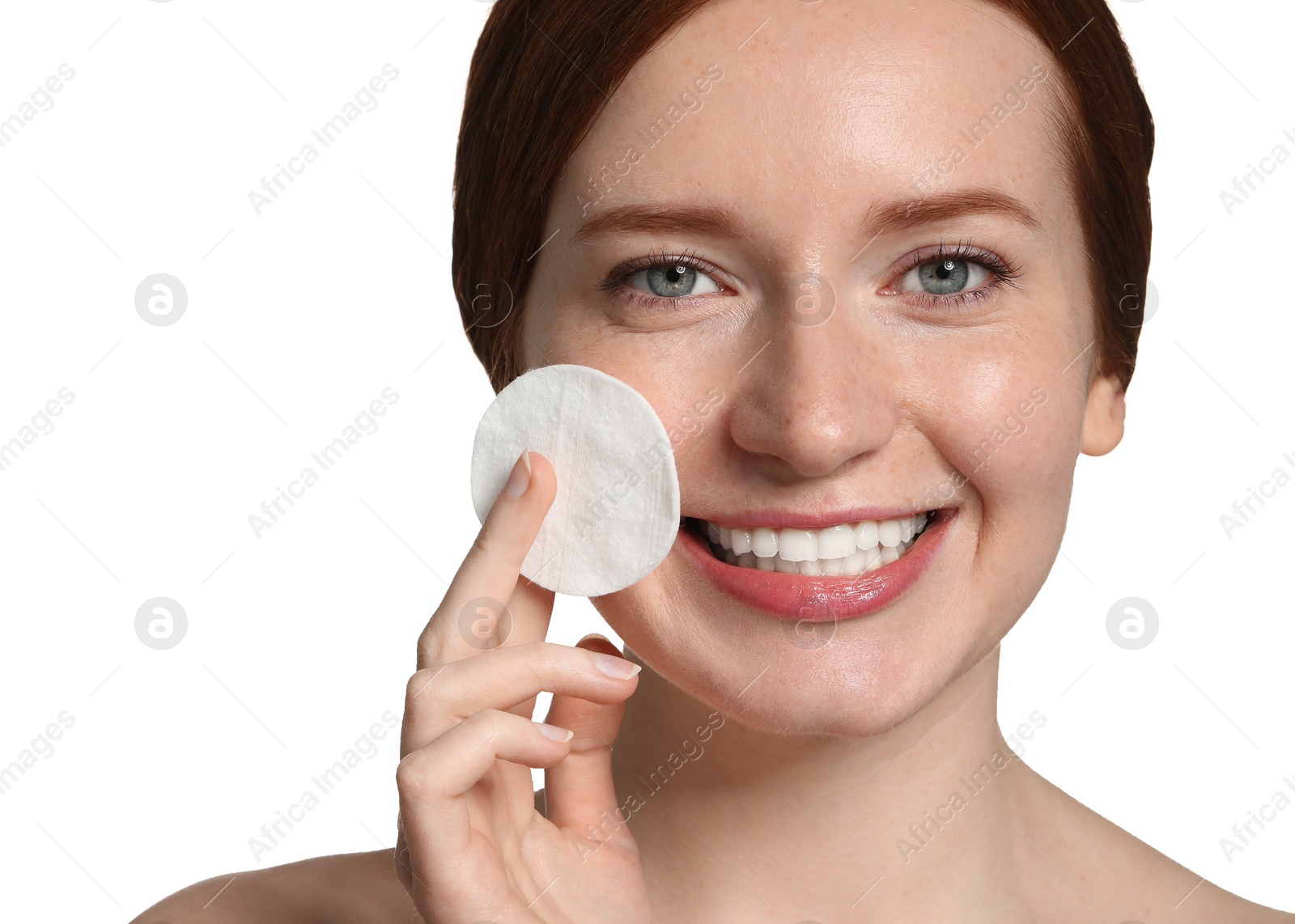 Photo of Smiling woman with freckles holding cotton pad on white background