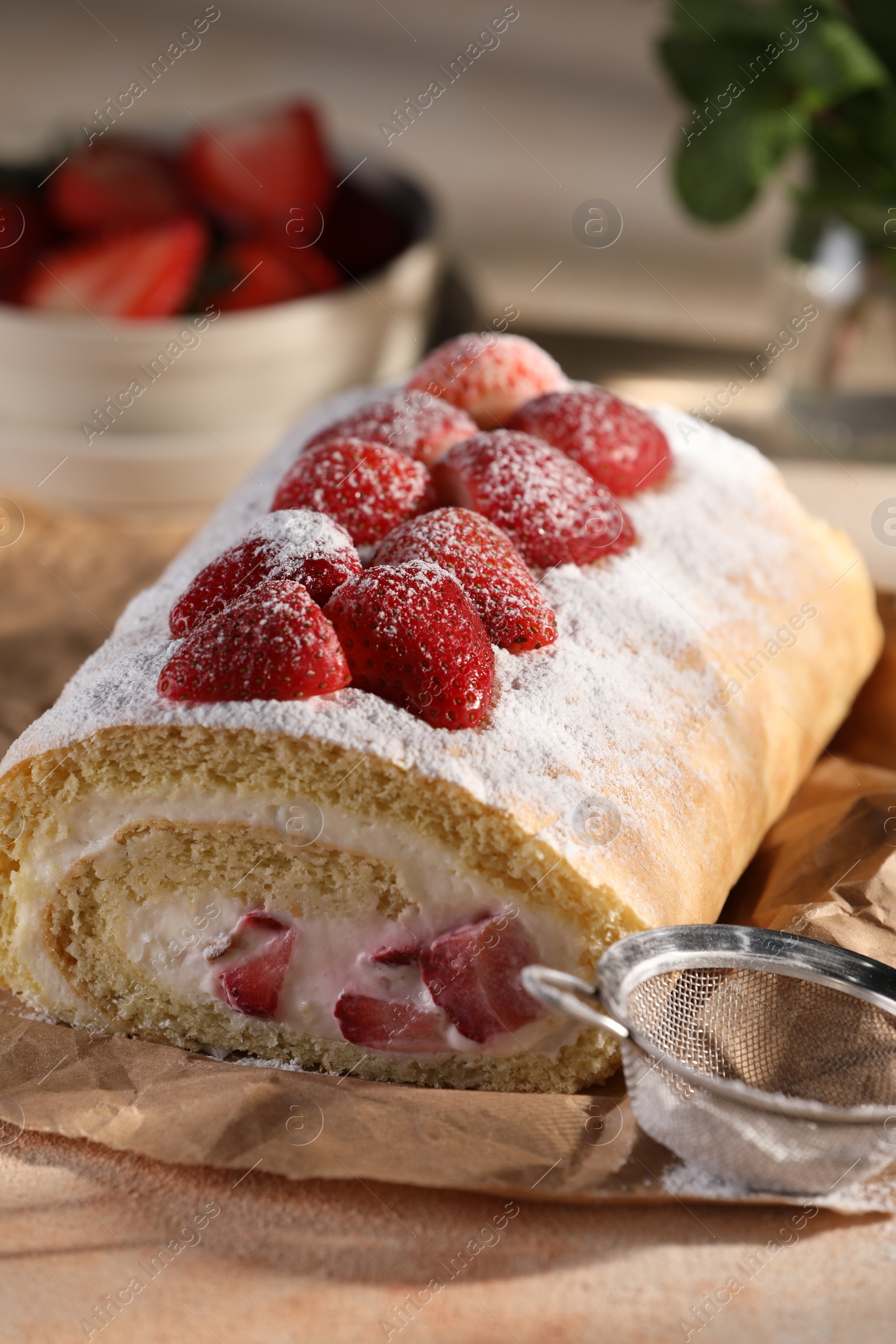 Photo of Delicious cake roll with strawberries and cream on table