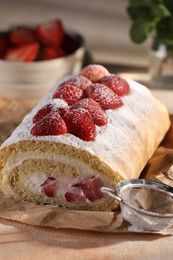 Photo of Delicious cake roll with strawberries and cream on table