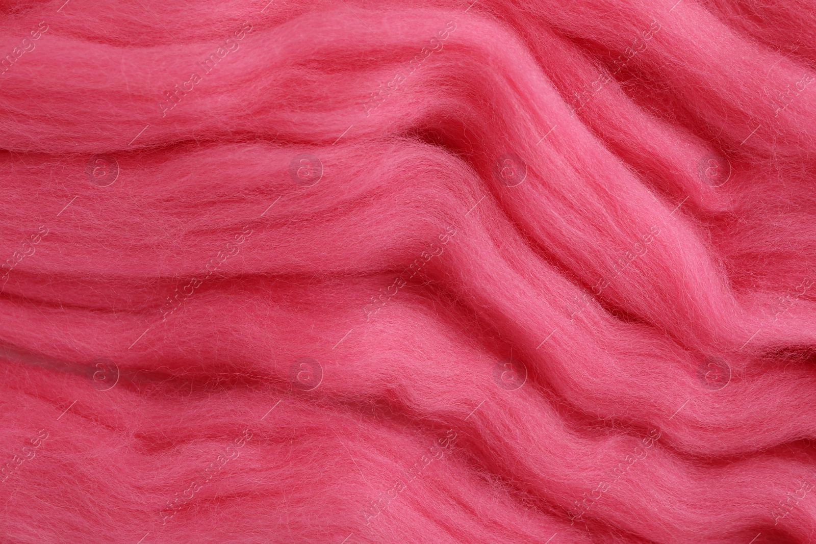 Photo of Pink felting wool as background, closeup view