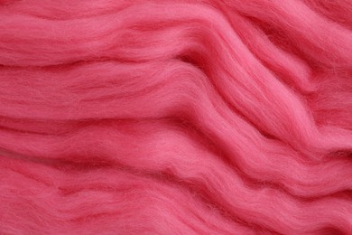 Pink felting wool as background, closeup view