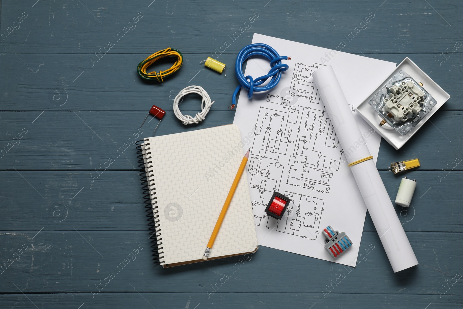 Photo of Flat lay composition with wiring diagram on blue wooden table, space for text