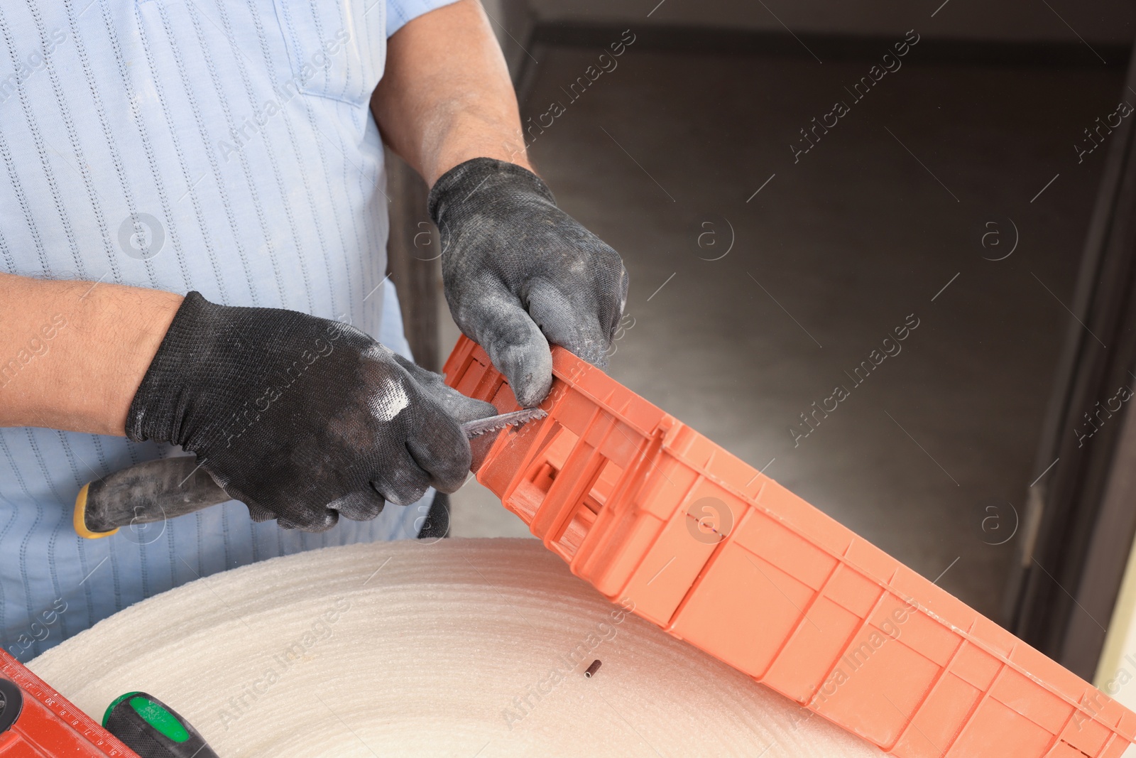 Photo of Electrician repairing switchboard indoors, closeup. Installation of electrical wiring