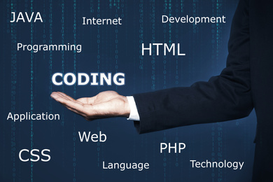 Image of Businessman and virtual screen with different words, closeup. Programming and coding 