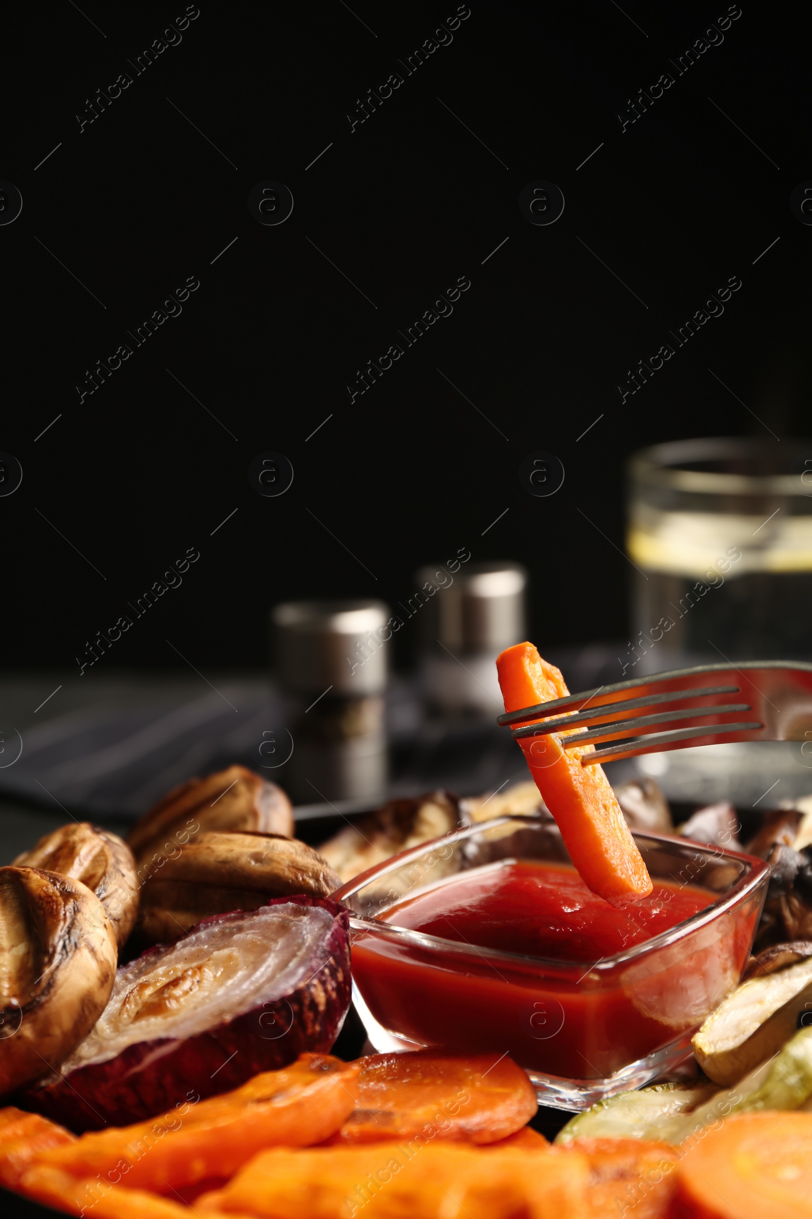 Photo of Delicious grilled vegetables and mushrooms served on grey table, closeup