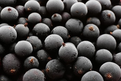 Tasty frozen black currants as background, closeup view