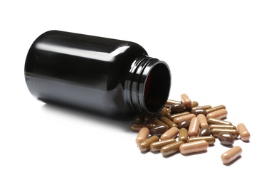 Photo of Bottle with vitamin capsules on white background