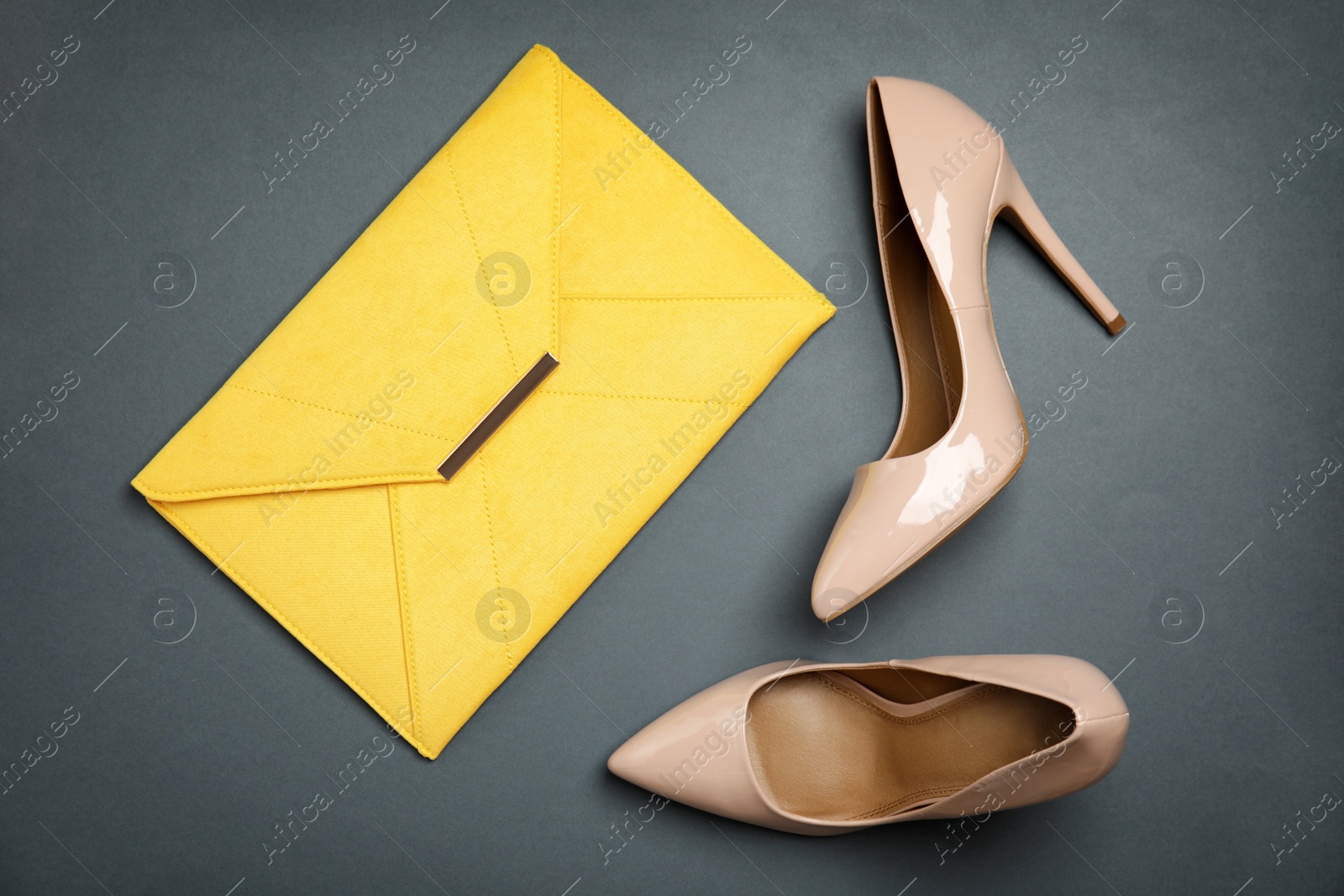 Photo of Pair of beautiful shoes and small bag on color background, top view