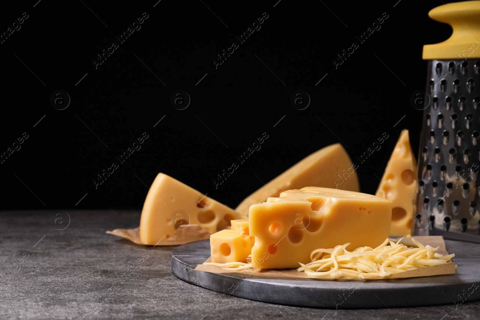 Photo of Tasty fresh cheese on grey table, space for text