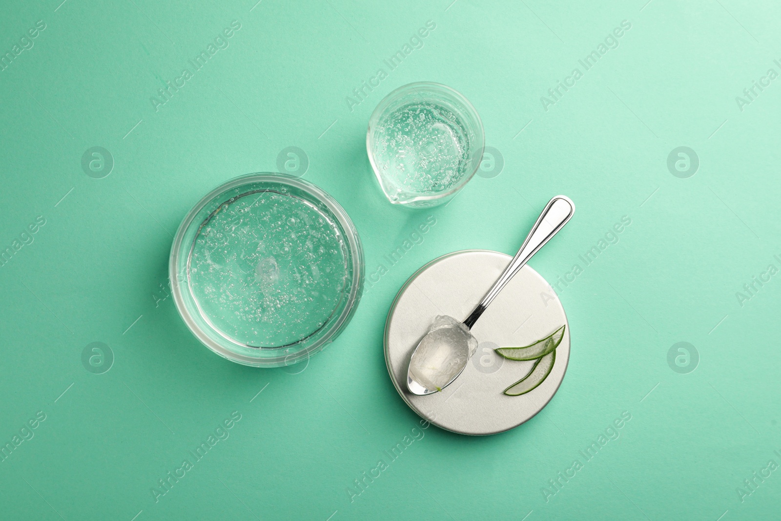 Photo of Flat lay composition with cosmetic gel and aloe on turquoise background