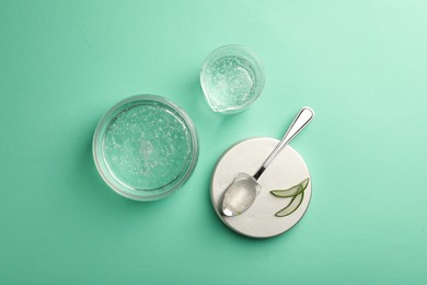 Flat lay composition with cosmetic gel and aloe on turquoise background