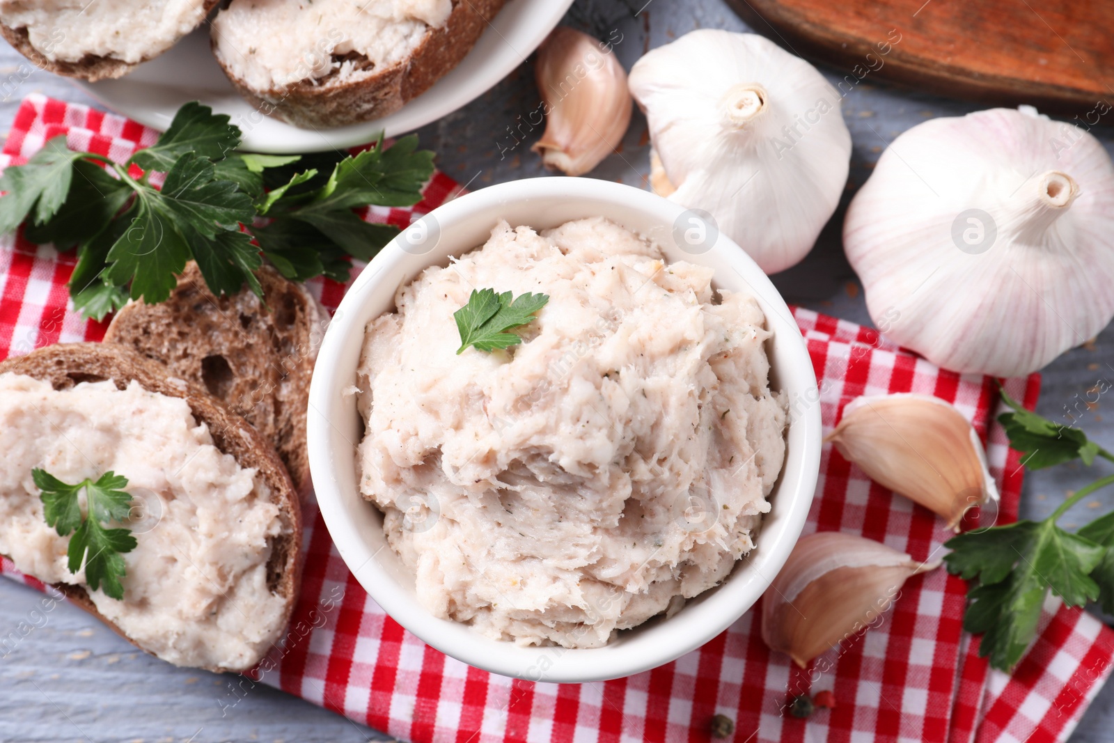 Photo of Lard spread served with bread on light grey wooden table, flat lay