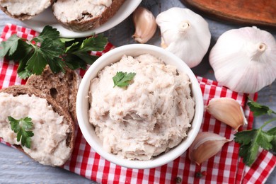 Lard spread served with bread on light grey wooden table, flat lay