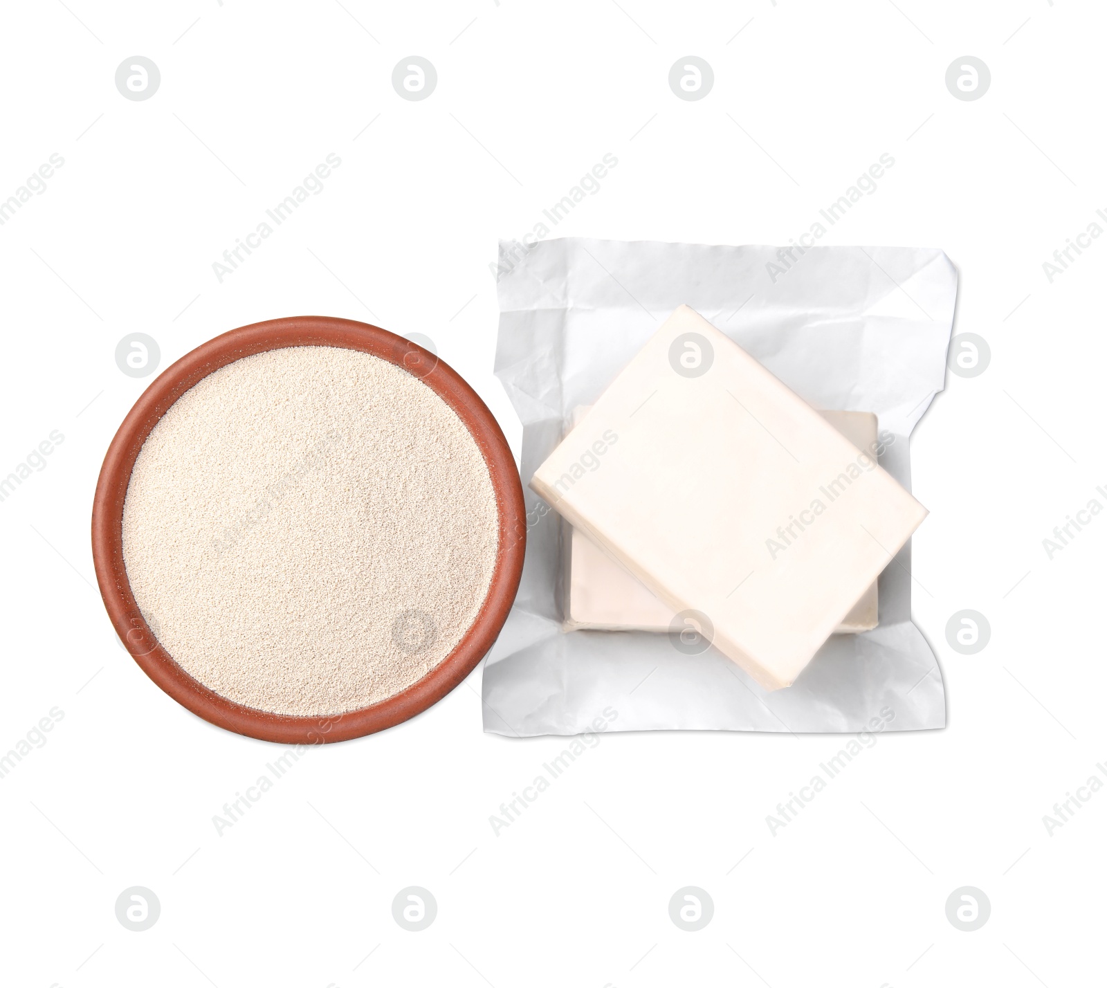 Photo of Compressed and granulated yeast on white background, top view