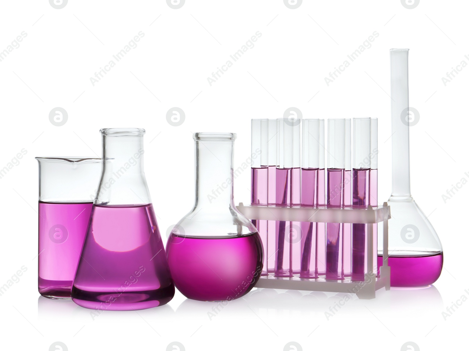 Photo of Laboratory glassware with purple liquid on white background