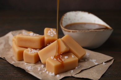 Pouring caramel on candies with sea salt at table, closeup