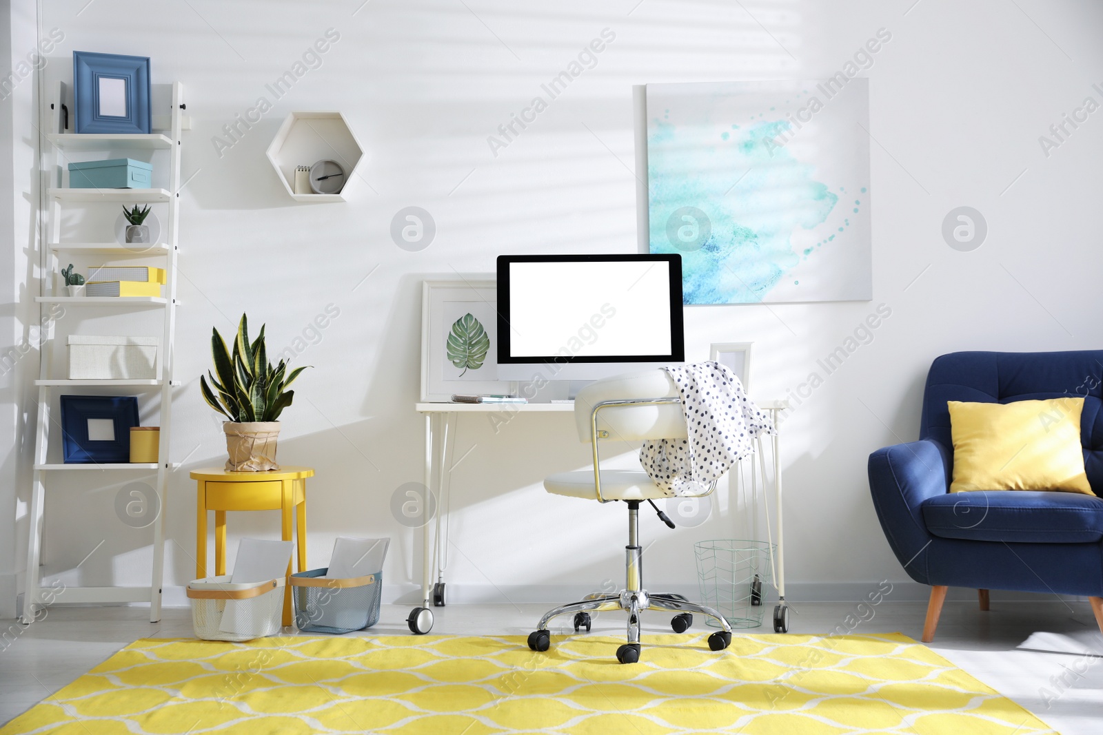 Photo of Comfortable office chair near desk with modern computer indoors