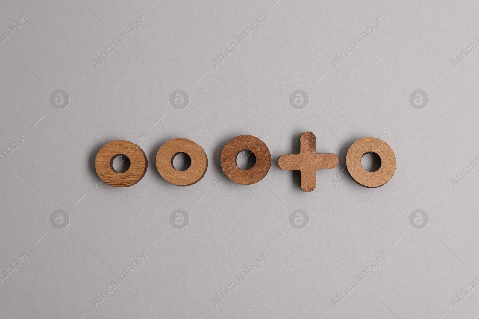 Photo of Choice concept. Wooden circles and cross on light grey background, flat lay