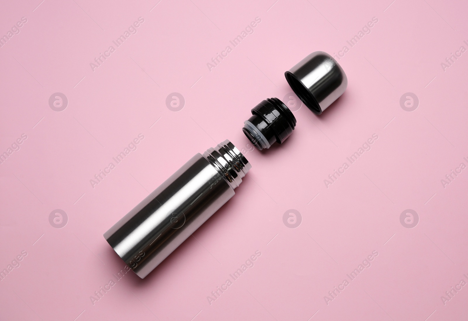 Photo of Stainless steel thermos on pink background, top view