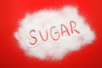 Composition with word SUGAR on red background, top view