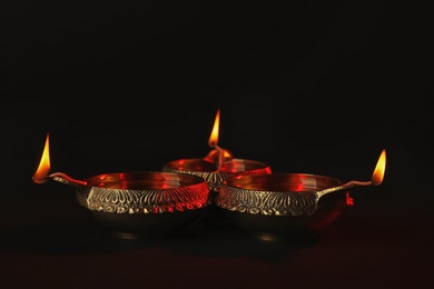 Diwali diyas or clay lamps on dark background