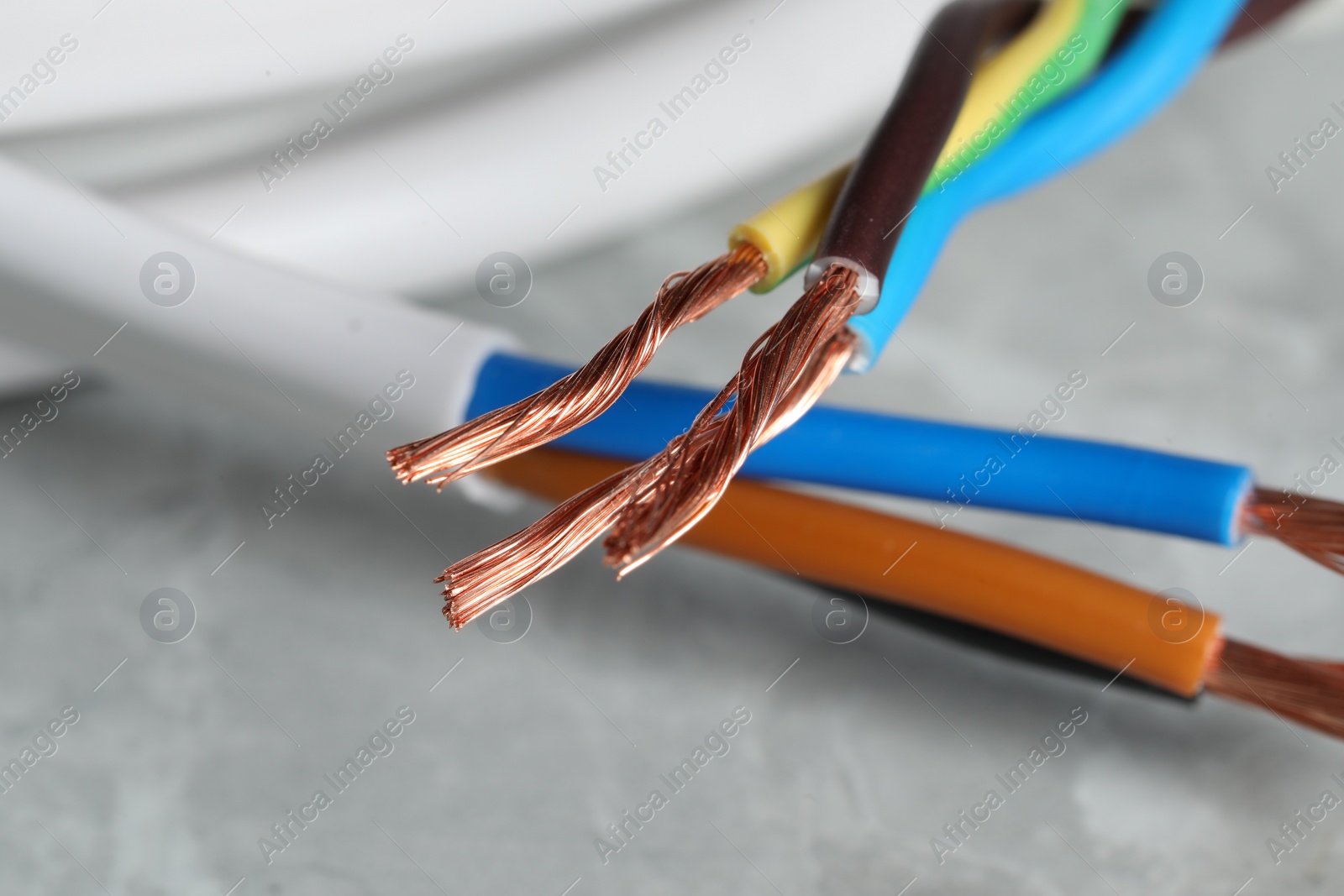 Photo of Colorful electrical wires on gray surface, closeup