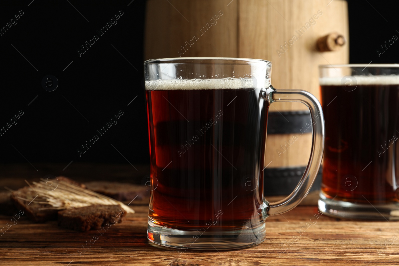 Photo of Delicious kvass, bread and spikes on wooden table