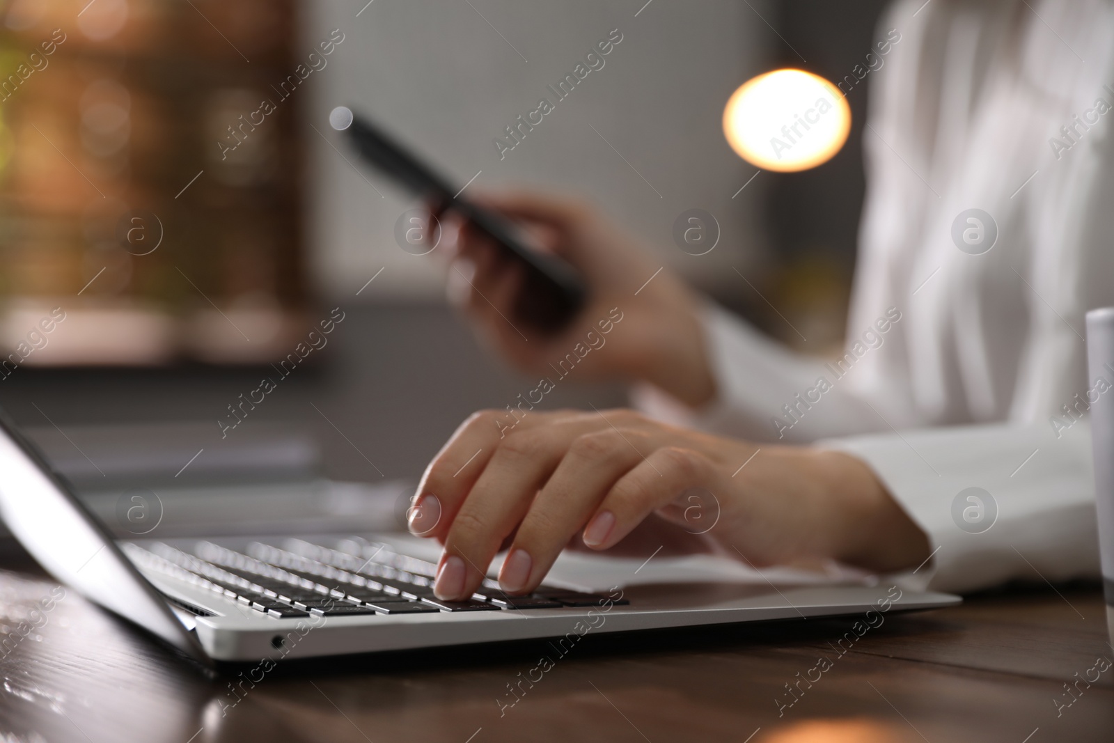 Photo of Woman working with laptop in office, closeup