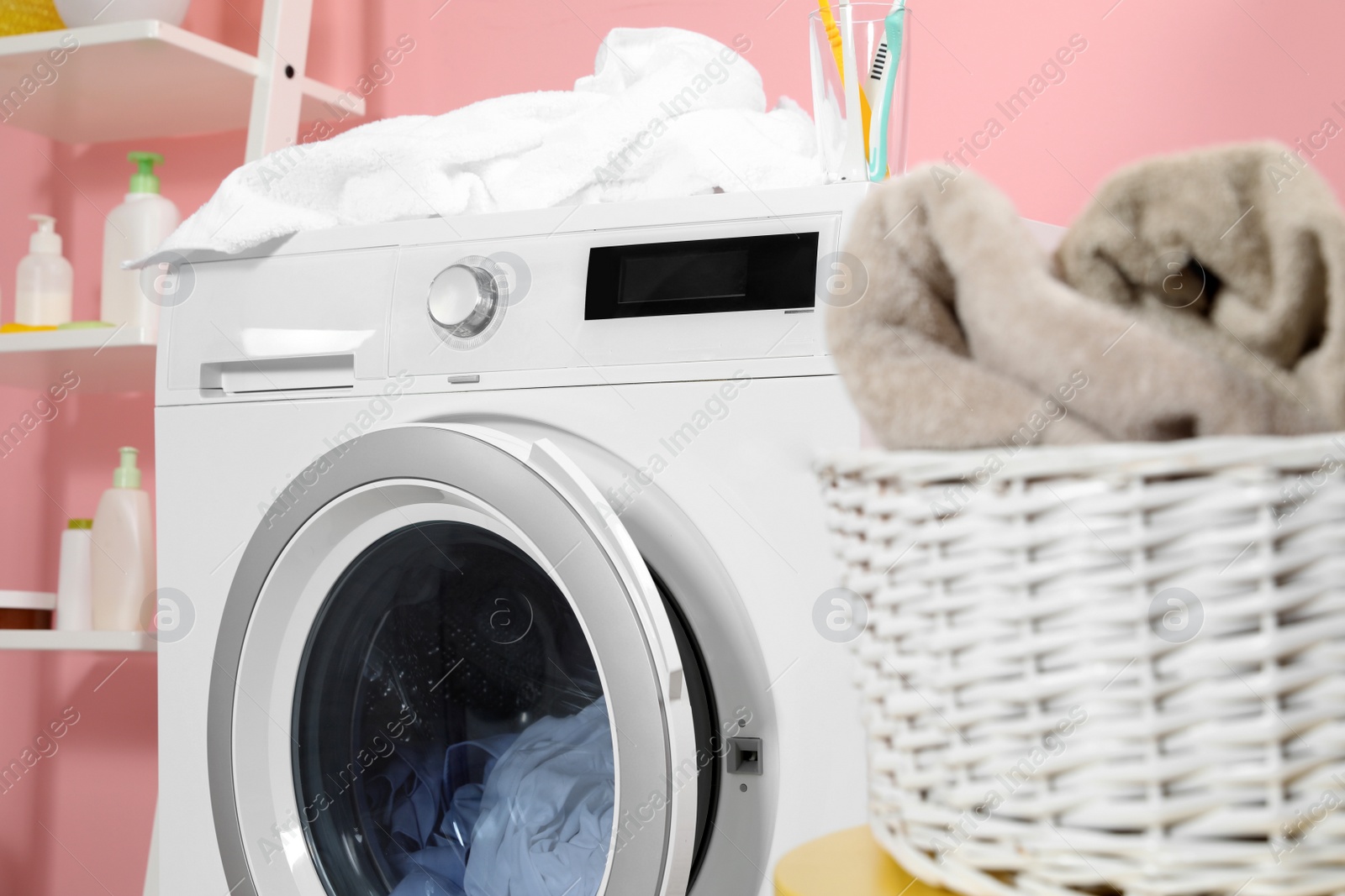 Photo of Modern washing machine in laundry room, closeup