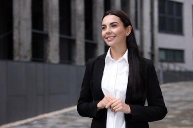 Portrait of smiling woman outdoors, space for text. Lawyer, businesswoman, accountant or manager