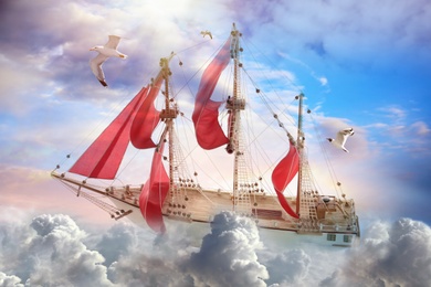 Dream world. Sailing ship floating among wonderful fluffy clouds