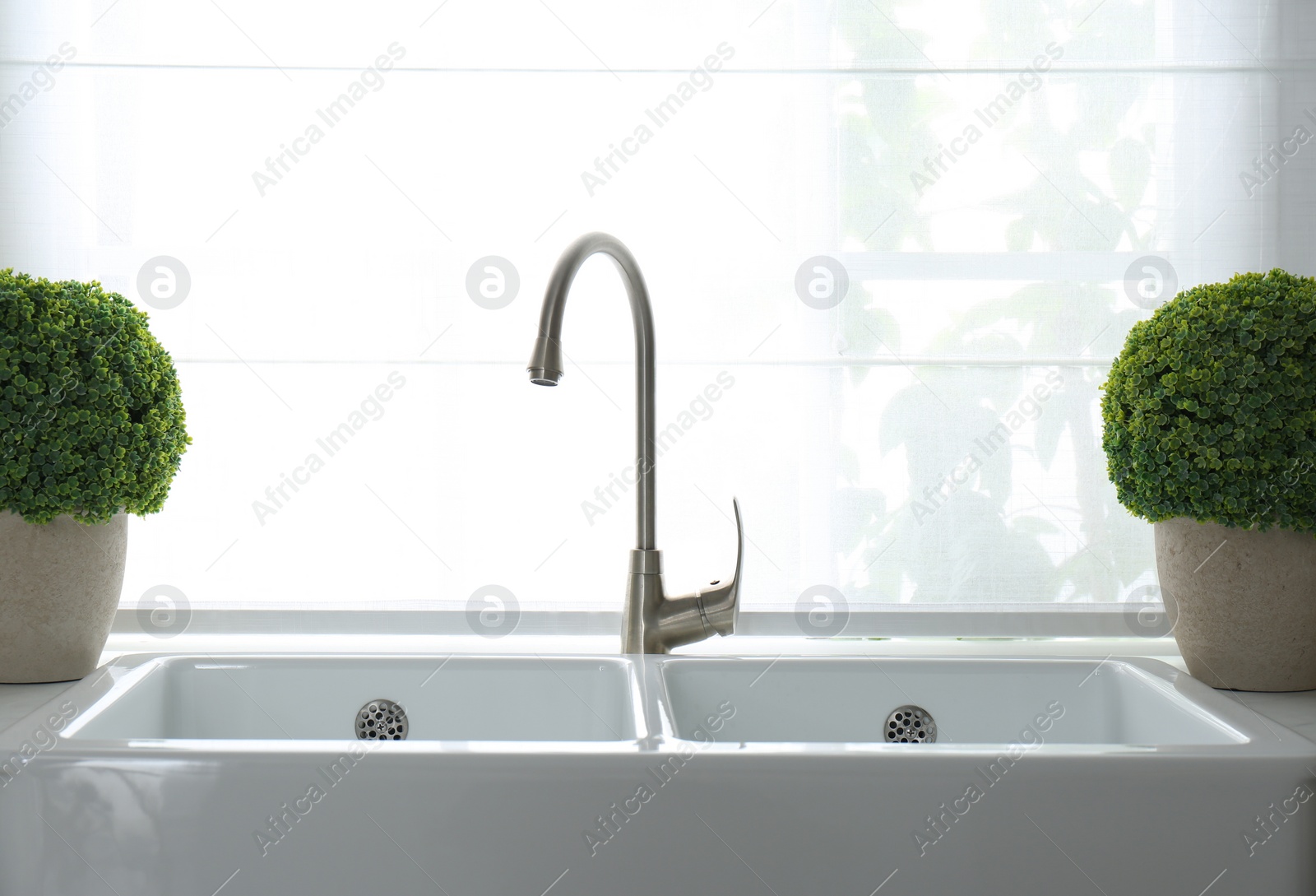 Photo of Modern double bowl sink near window in kitchen