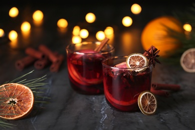 Mulled wine with cinnamon, anise and orange in glasses on table