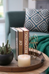 Image of Books with phrase Culture of Belonging on wooden table in room