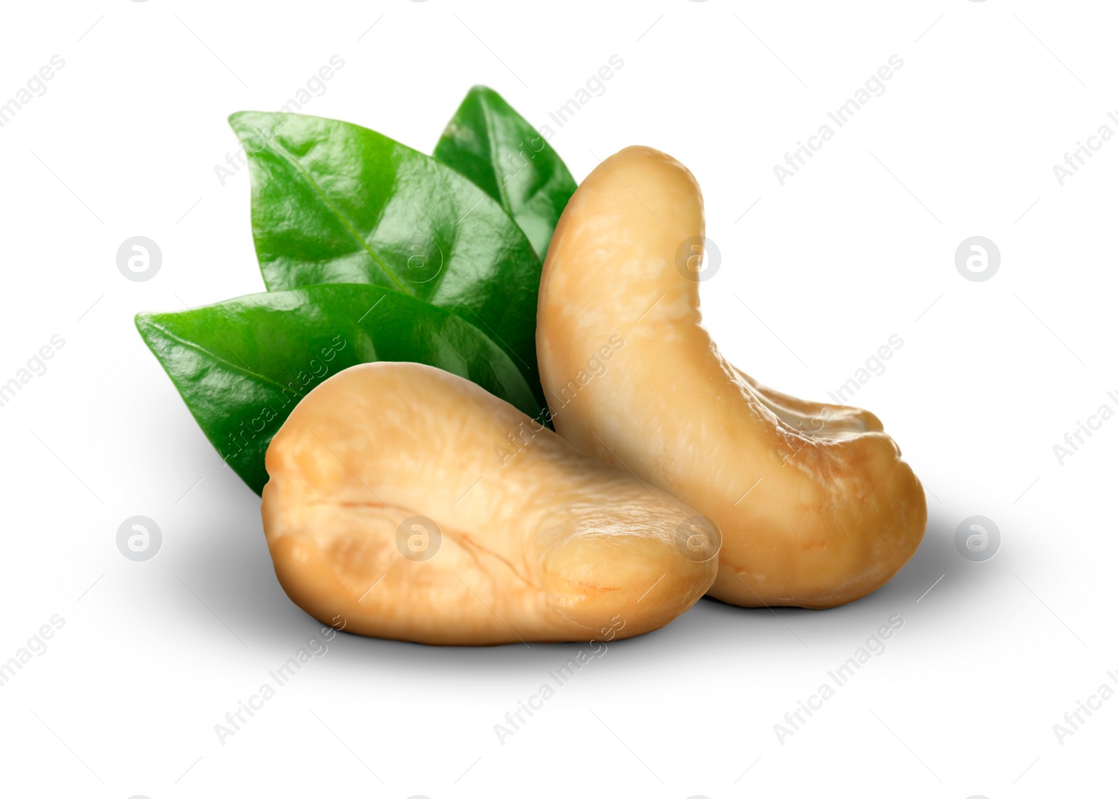 Image of Tasty cashew nuts and fresh green leaves on white background 