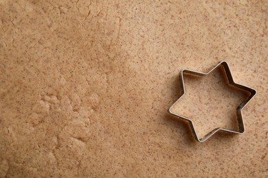 Homemade Christmas biscuits. Cookie cutter on raw dough, top view