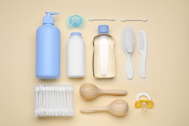 Flat lay composition with baby care products and accessories on beige background