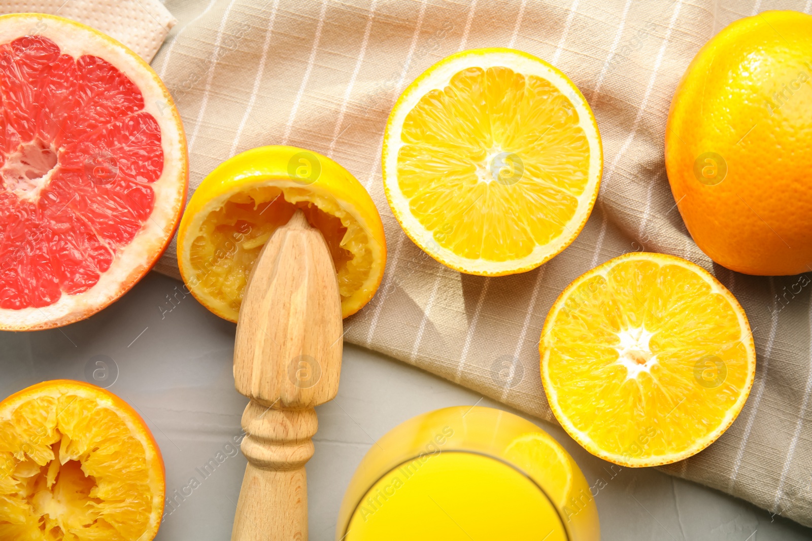 Photo of Flat lay composition with oranges and reamer on light grey table