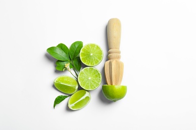 Flat lay composition with lime, mint and juicer on light background. Refreshing beverage ingredients