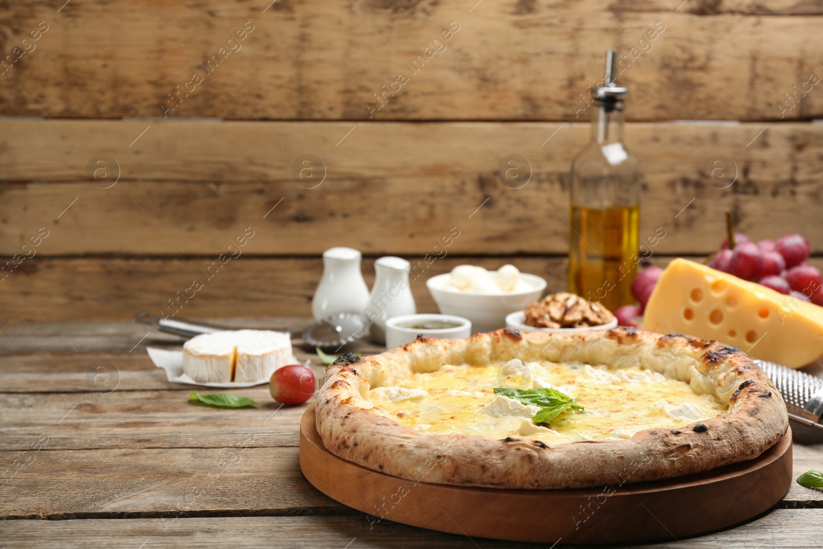 Photo of Delicious cheese pizza on wooden table. Space for text