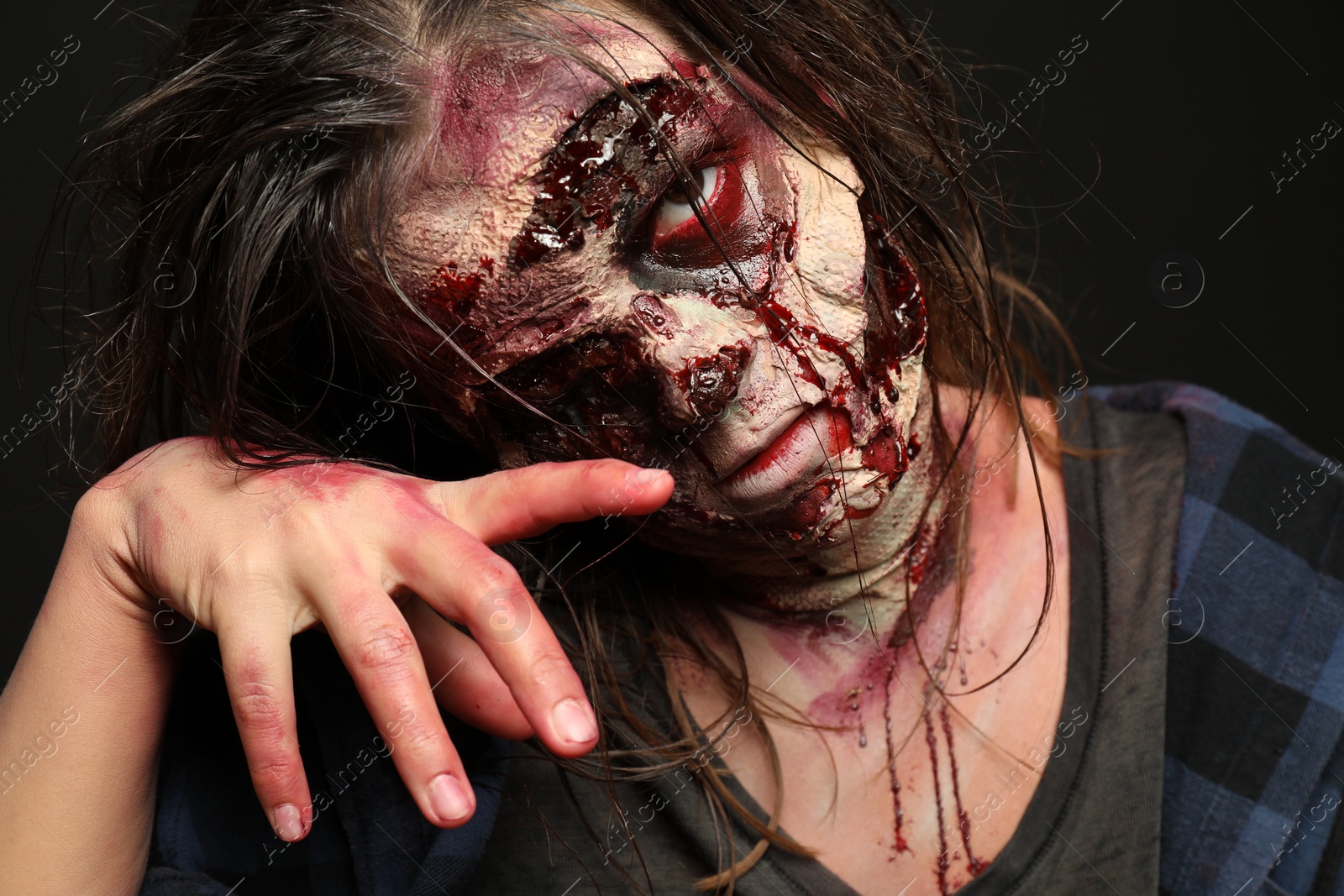 Photo of Scary zombie on dark background, closeup. Halloween monster