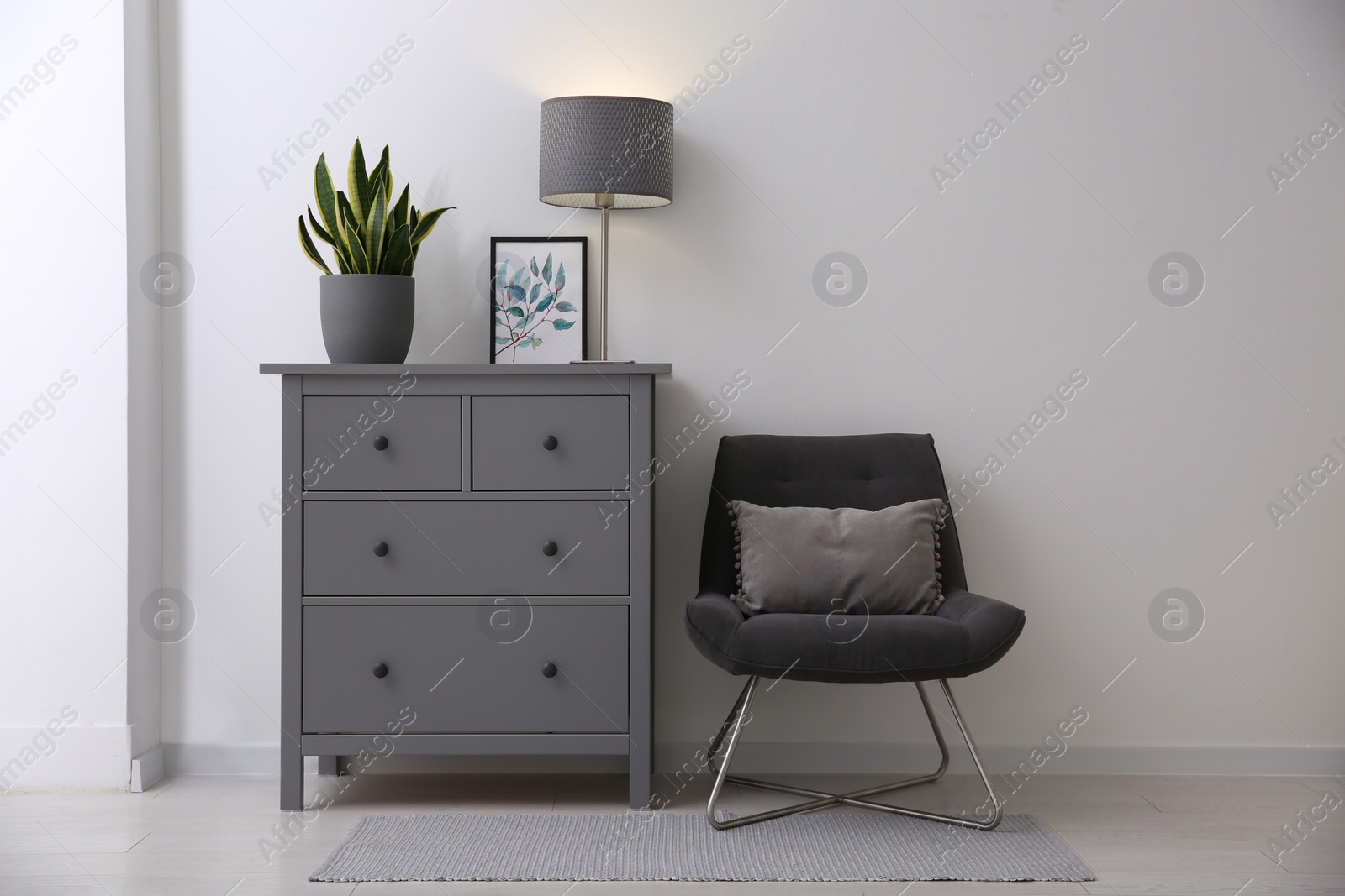 Photo of Grey chest of drawers in stylish room interior