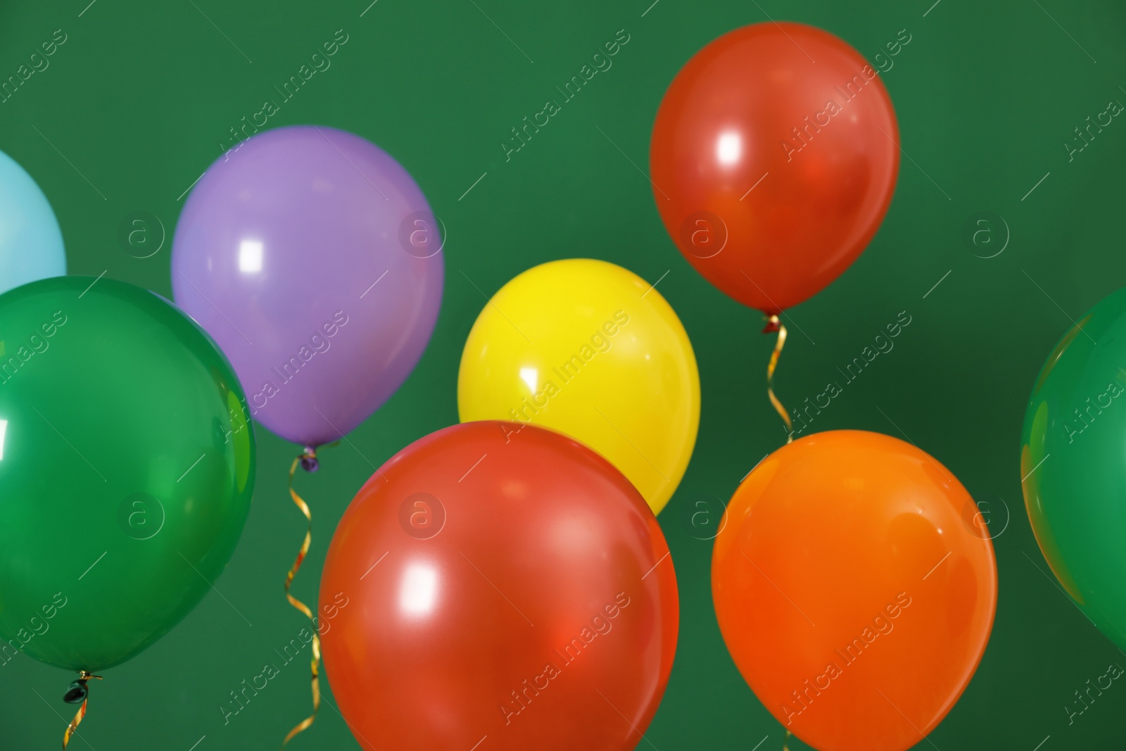 Photo of Bright balloons on color background. Celebration time