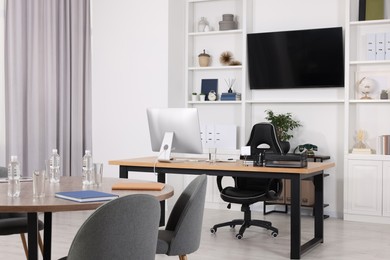 Stylish office with comfortable furniture and tv zone. Interior design