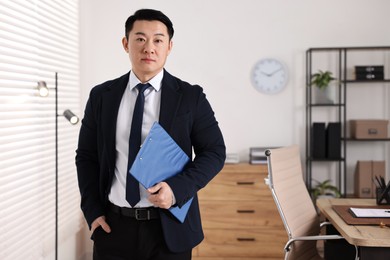 Photo of Portrait of confident notary with clipboard in office, space for text