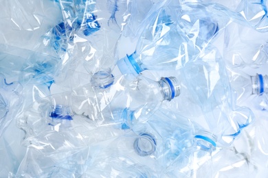 Photo of Many used plastic bottles as background, top view. Recycling problem