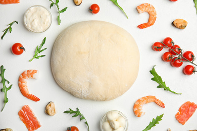 Photo of Flat lay composition with dough and fresh ingredients for seafood pizza on white table
