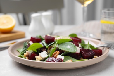 Delicious beet salad served on grey table, closeup