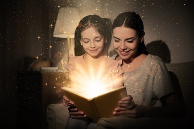 Image of Little girl with mother reading fairy tale at home in evening