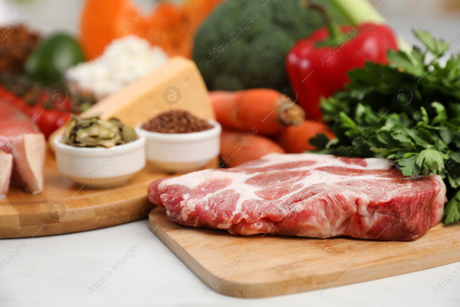 Photo of Fresh meat and parsley on white table, space for text. Keto diet